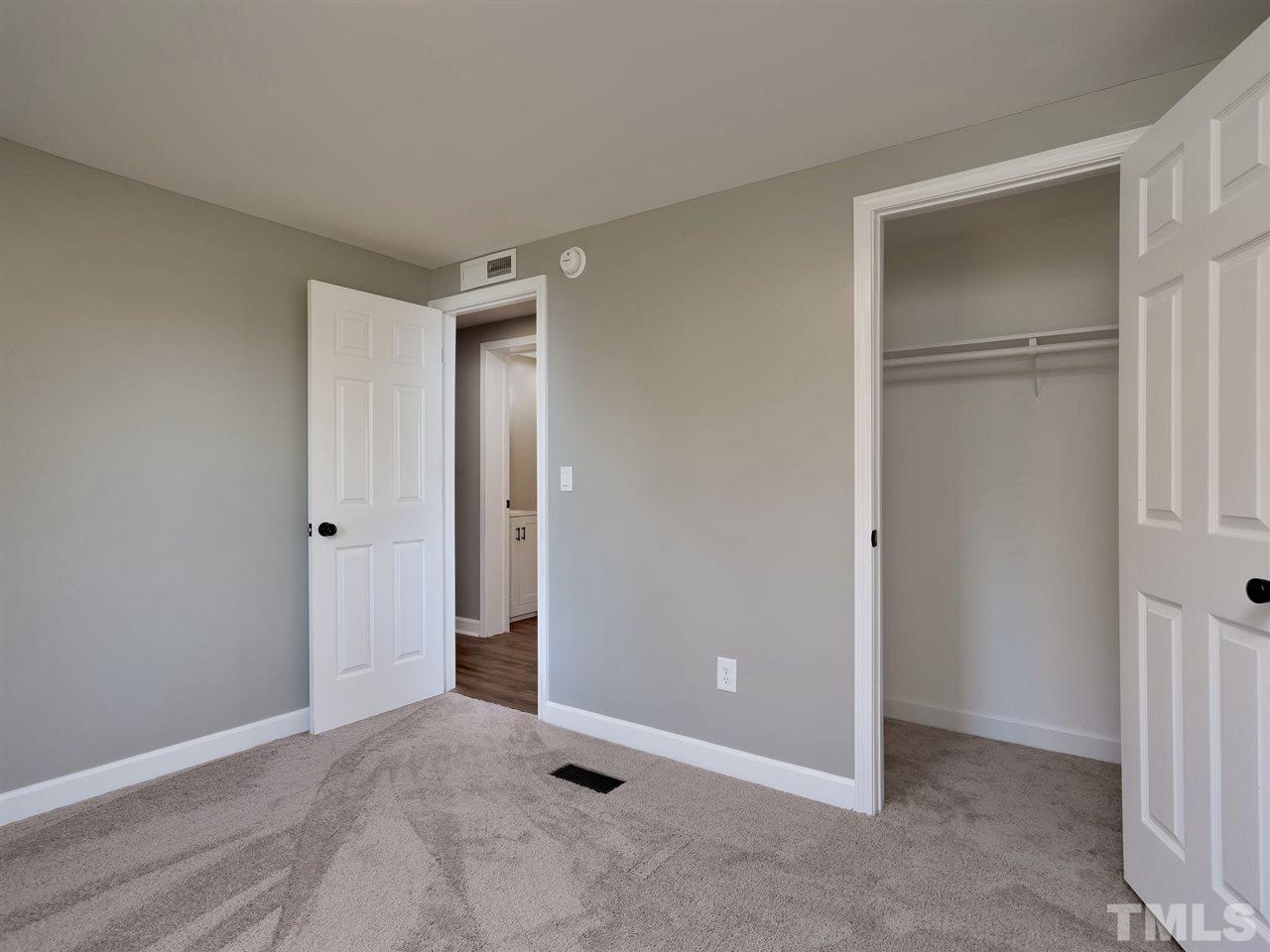 1825 Wire Road Bunnlevel, NC 28323 - Photo 18 of 30 Brand new carpet and large walk in closet, make this bedroom with lots of natural sunlight very cozy.