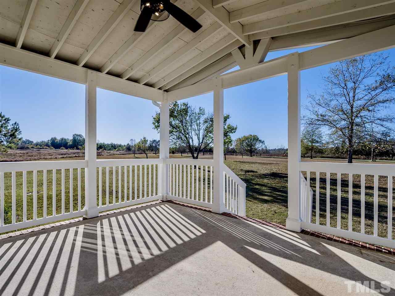 1825 Wire Road Bunnlevel, NC 28323 - Photo 6 of 30 Brand new custom rocking chair front porch complete with state of the art remote control fan with security modes that can be activated before leaving home.