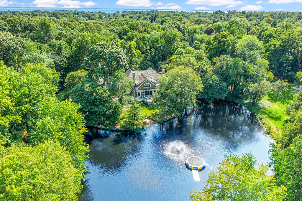 20 Driftway Lane Darien, CT 06820 - Photo 1 of 76 a view of a lake with a yard
