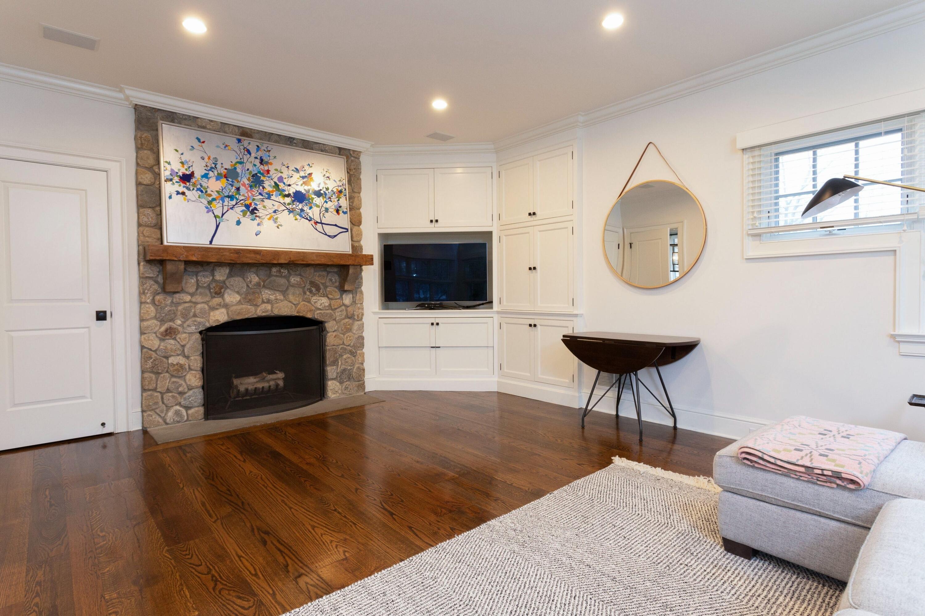 20 Driftway Lane Darien, CT 06820 - Photo 31 of 76 a living room with furniture a clock and a fireplace