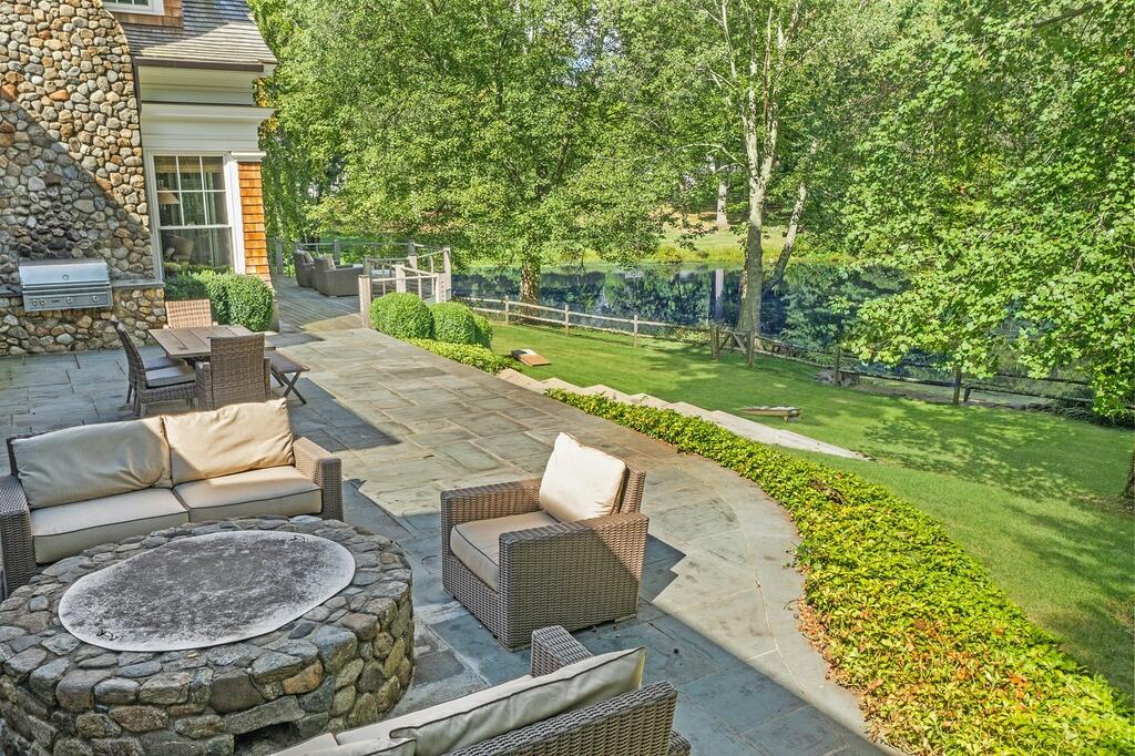 20 Driftway Lane Darien, CT 06820 - Photo 55 of 76 a view of a patio with couches table and chairs and potted plants