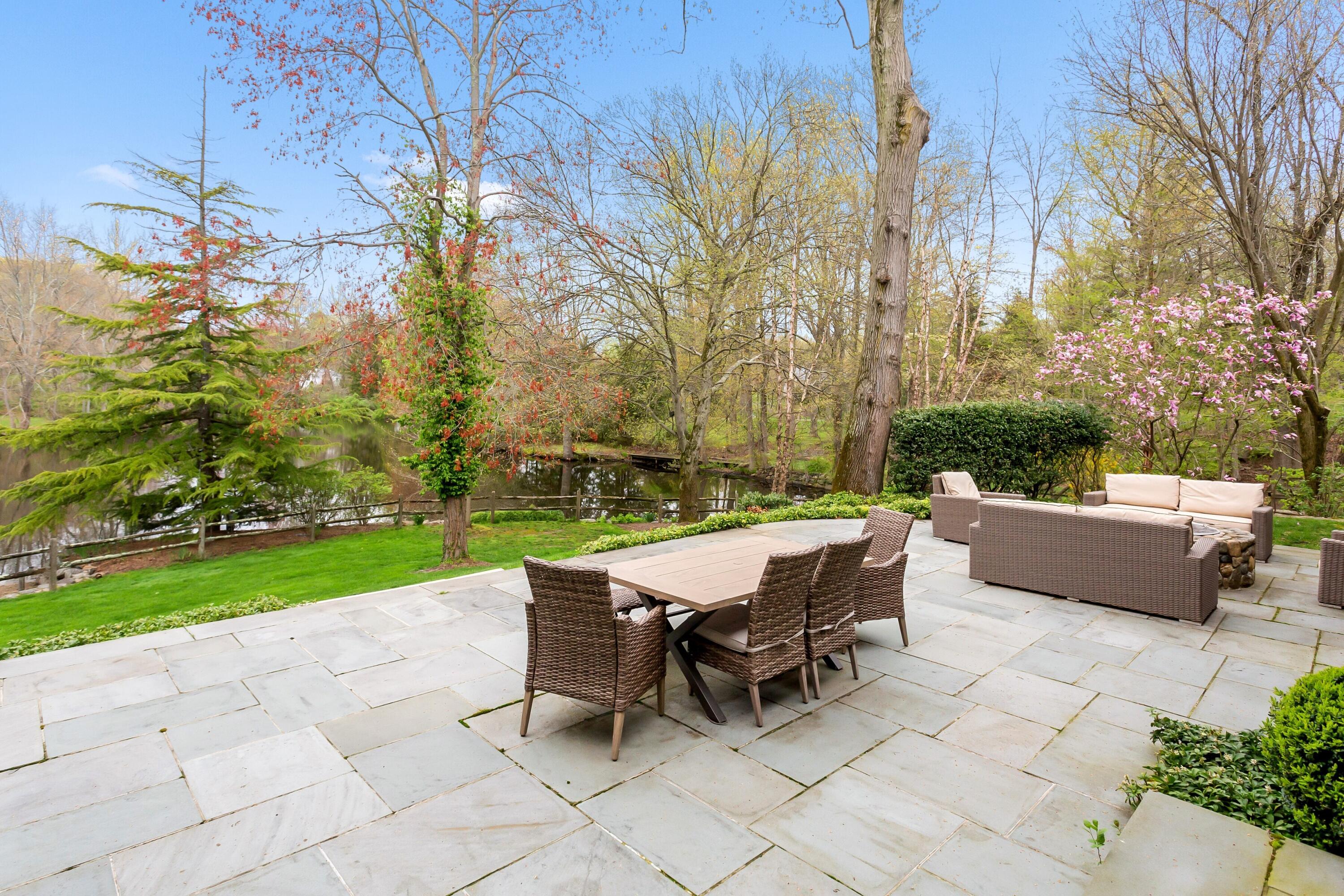 20 Driftway Lane Darien, CT 06820 - Photo 57 of 76 a view of a patio with a table and chairs