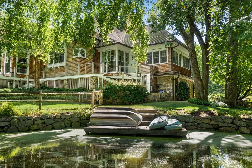20 Driftway Lane Darien, CT 06820 - Photo 58 of 76 a front view of a house with a yard table and chairs
