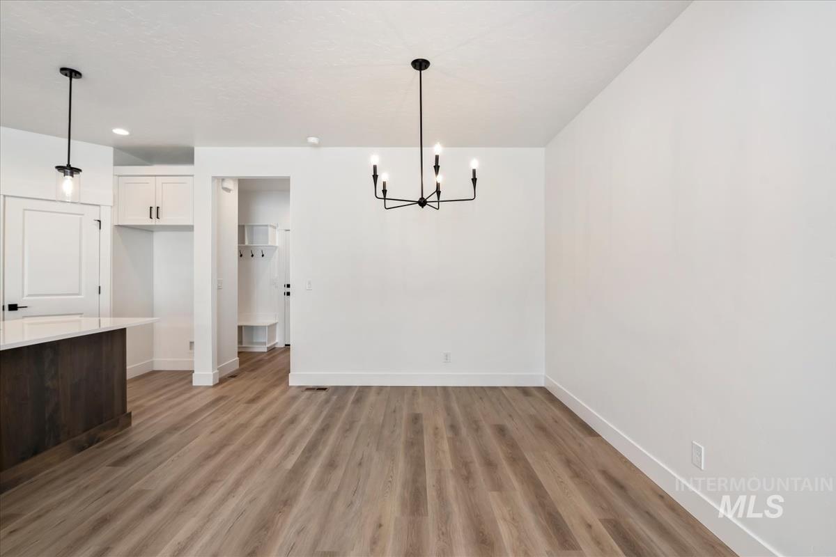 768 South Calhoun Lane Star, ID 83669 - Photo 7 of 36 Open-concept living space with wood-finish flooring