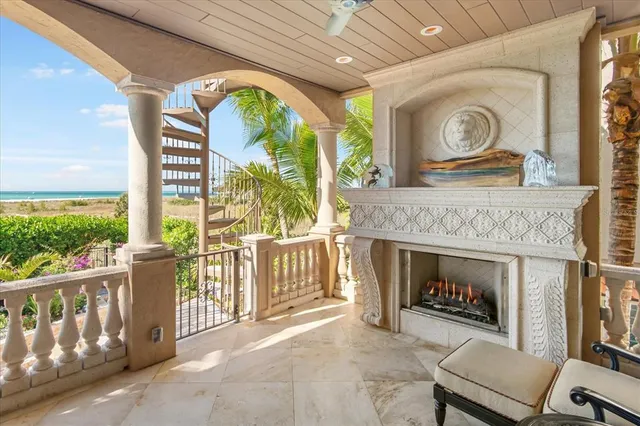 a view of a livingroom with furniture a fireplace chandeliers and fan