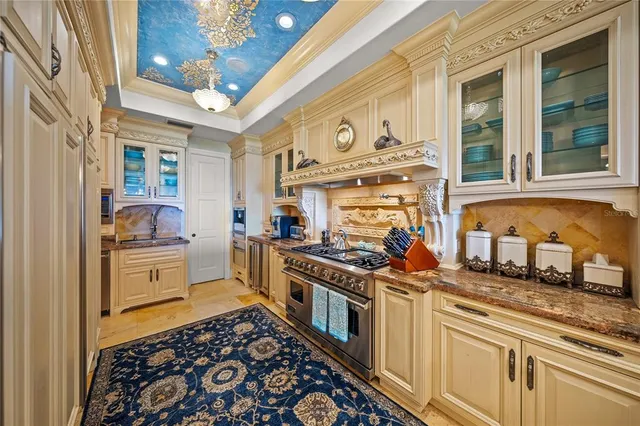 a en suite bathroom with a granite countertop sink and a mirror