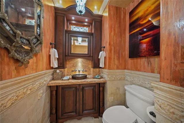 a kitchen with stainless steel appliances granite countertop a sink and wooden cabinets