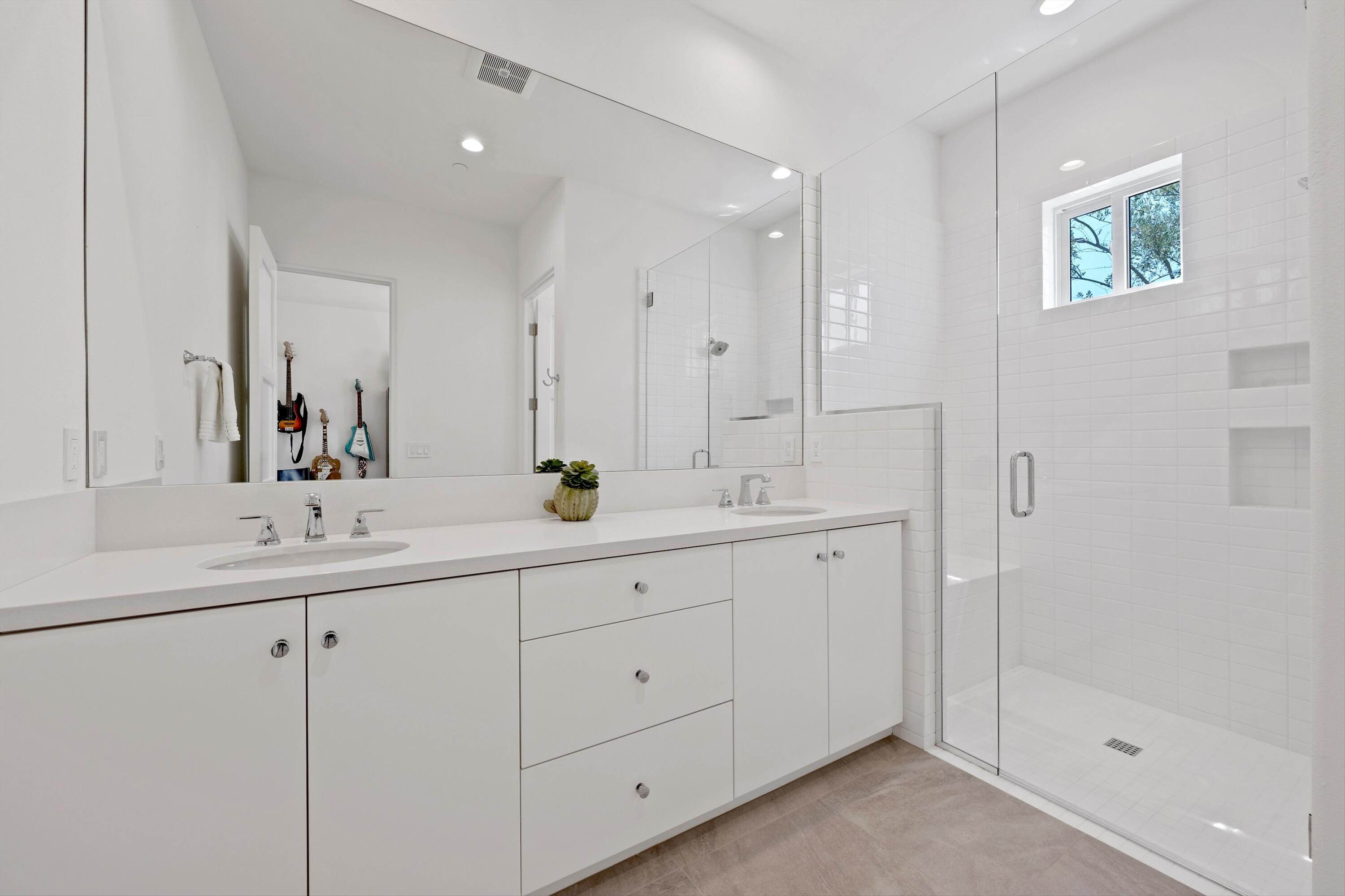 58892 Marbella La Quinta, CA 92253 - Photo 26 of 65 a bathroom with double sink and a mirror
