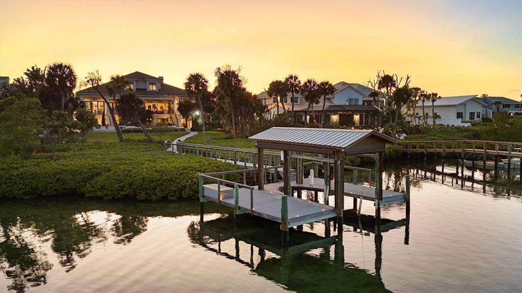 3210 Casey Key Road Nokomis, FL 34275 - Photo 16 of 77 a view of a chairs and table in the patio and a lake view
