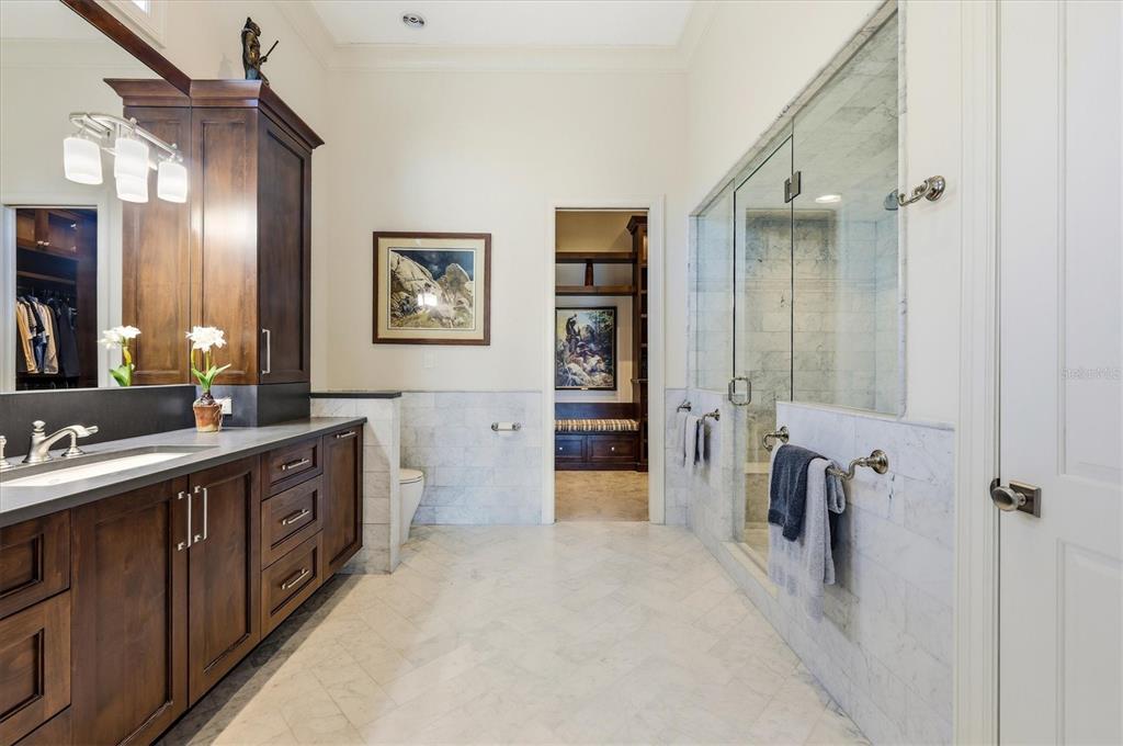 3210 Casey Key Road Nokomis, FL 34275 - Photo 36 of 77 a spacious bathroom with a double vanity sink a mirror a shower and a bathtub