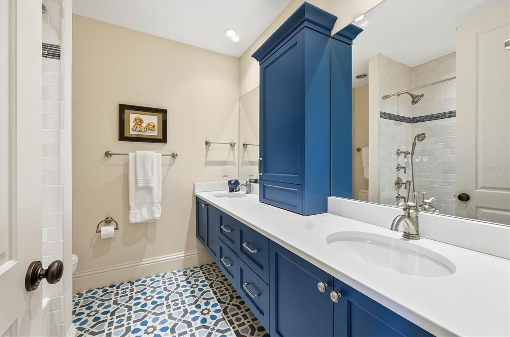 3210 Casey Key Road Nokomis, FL 34275 - Photo 47 of 77 a bathroom with a double vanity sink a mirror and a shower