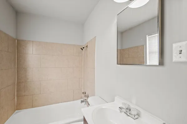 a bathroom with a sink mirror and vanity