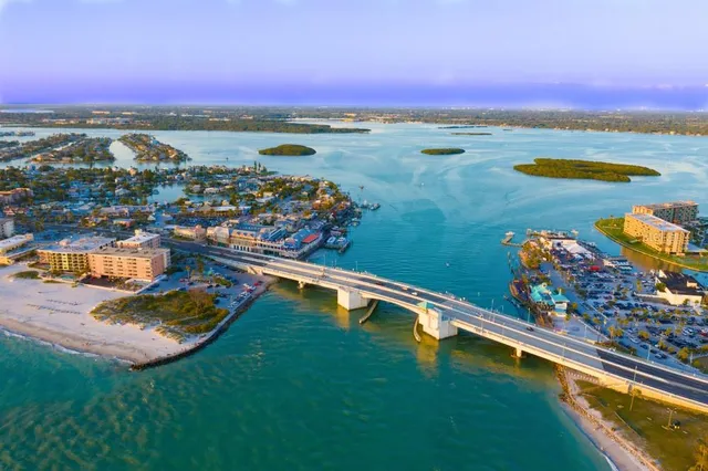 an aerial view of residential houses with outdoor space and river view