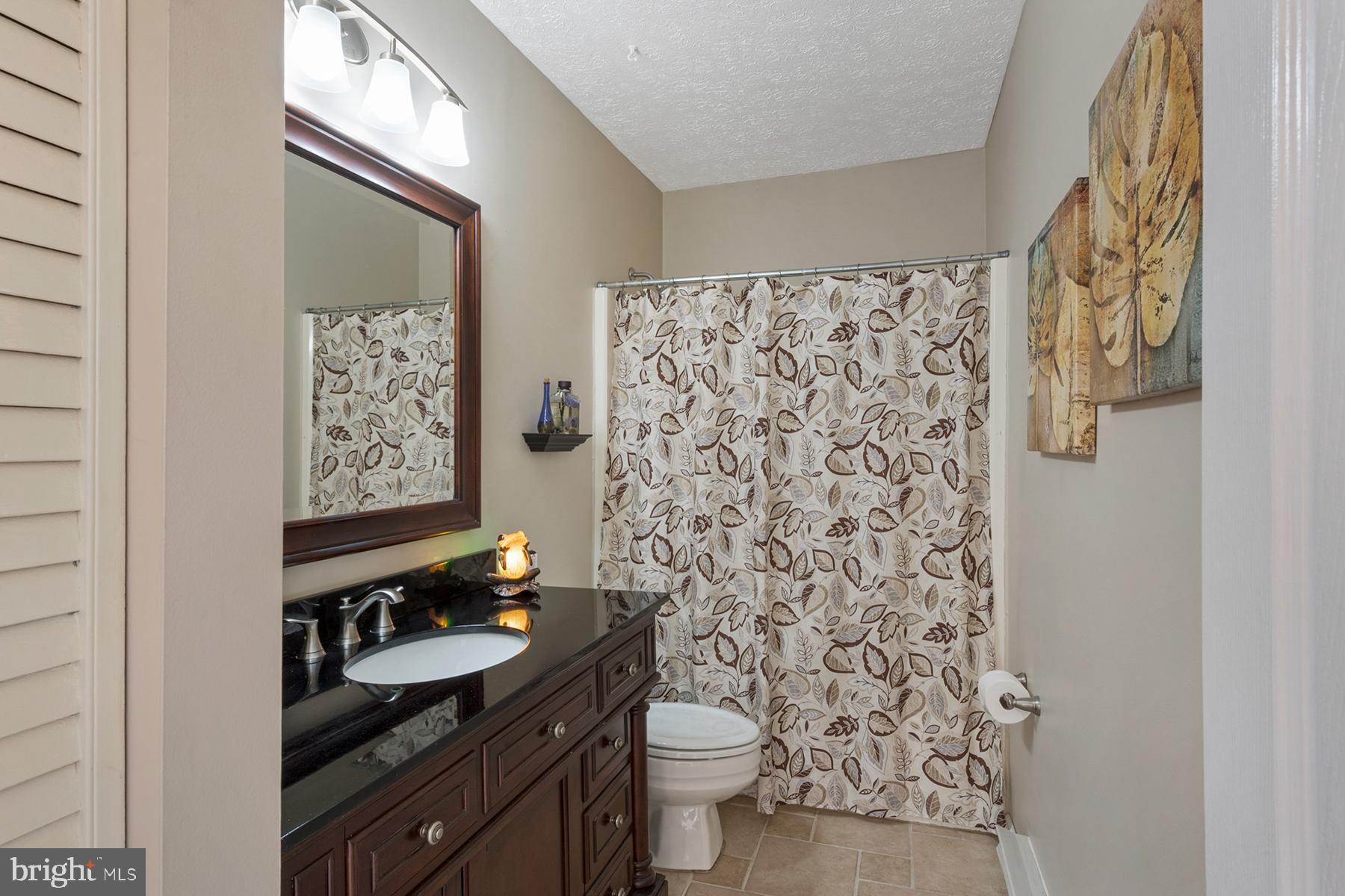 1253 Magothy Road Pasadena, MD 21122 - Photo 19 of 49 A full bathroom is on the main level