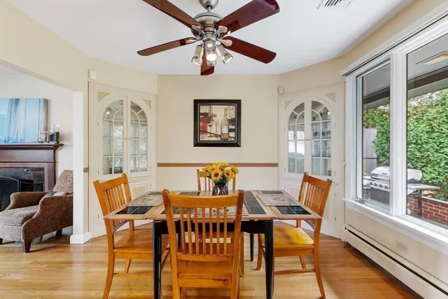 a dining room with furniture a flat screen tv and a large window