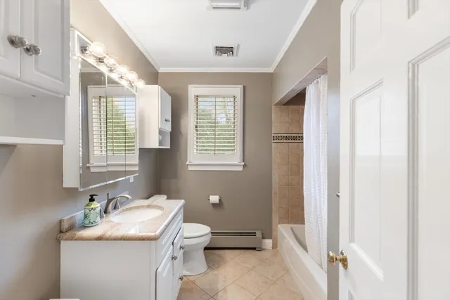 a bathroom with a granite countertop sink toilet and mirror