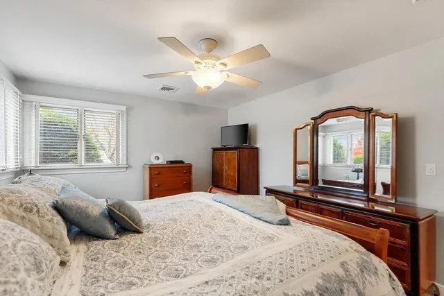 a bedroom with a large bed and a chandelier