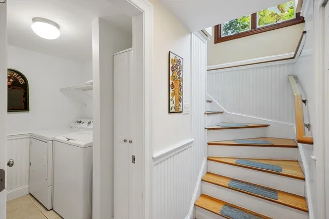 a view of staircase with white walls and a window