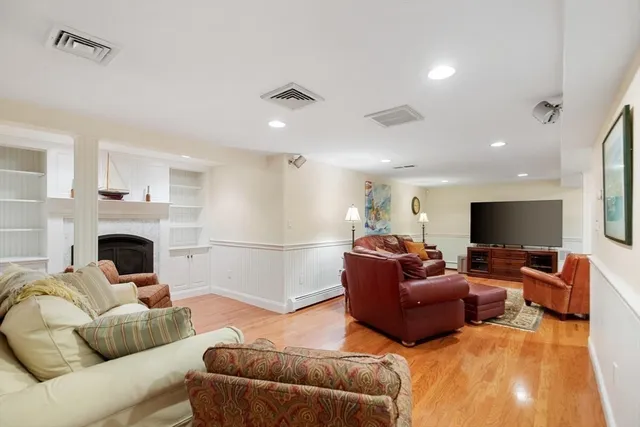 a living room with furniture a flat screen tv and a fireplace