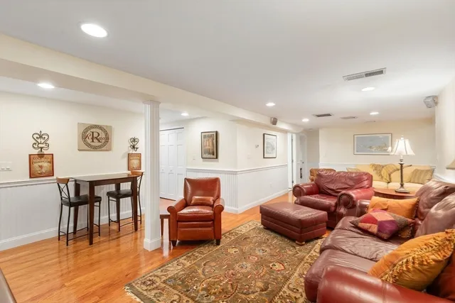 a living room with furniture wooden floor and a rug