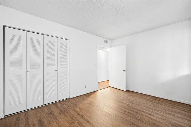 a bathroom with a bathtub shower sink vanity mirror and toilet