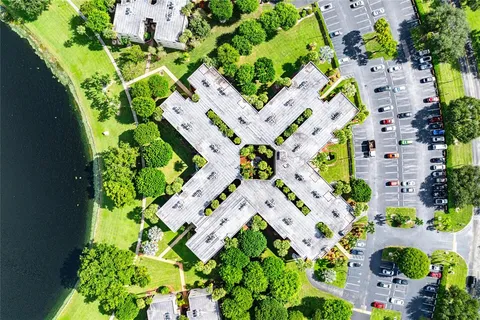 an aerial view of a house with a yard and lake view