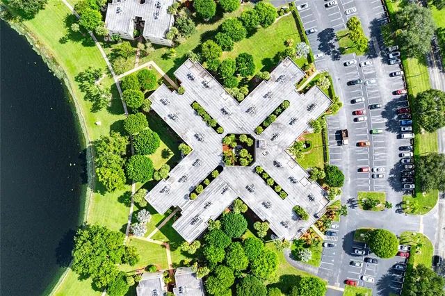 an aerial view of a house with a yard and lake view