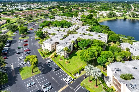an aerial view of residential houses with outdoor space and swimming pool