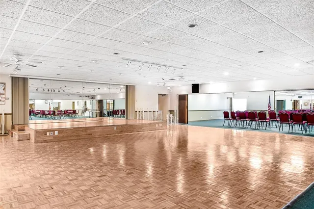 a room with pool table and windows