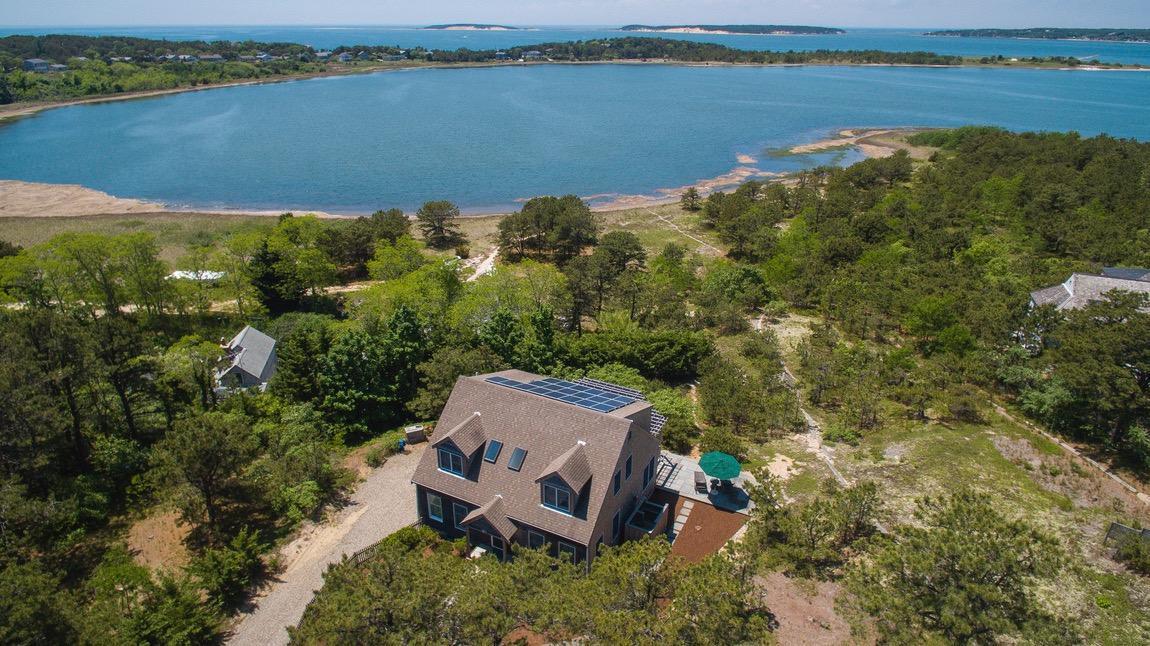 334 Cove Road Wellfleet, MA 02667 - Photo 1 of 32 an aerial view of a house with a lake view