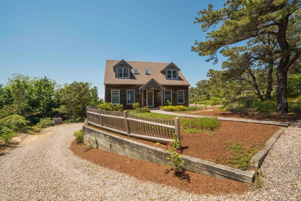 334 Cove Road Wellfleet, MA 02667 - Photo 4 of 32 a front view of a house with a yard