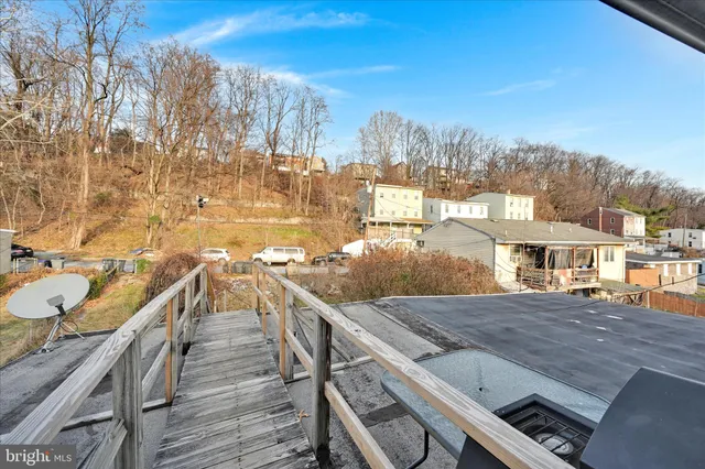a view of a balcony with wooden floor and outdoor space