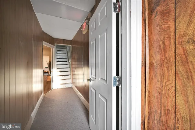 a view of a hallway with wooden floor and windows