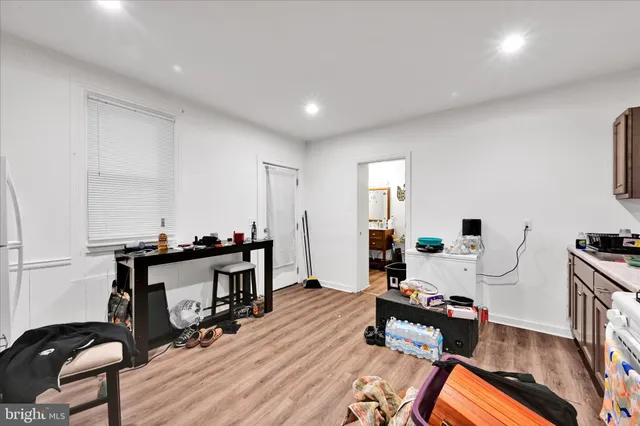 a living room with furniture a wooden floor and next to a window