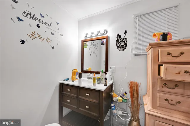 a bathroom with a sink vanity and mirror