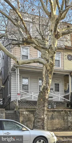 front view of a house with a tree