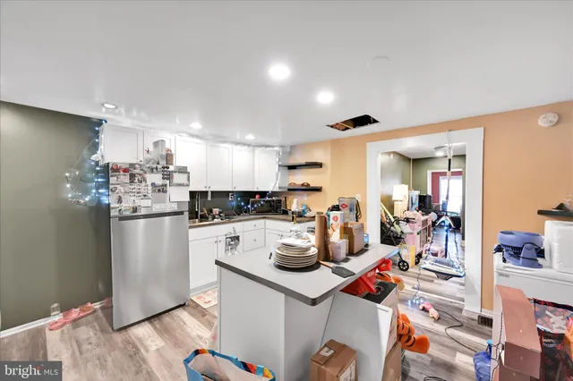 a kitchen with a refrigerator and a stove top oven