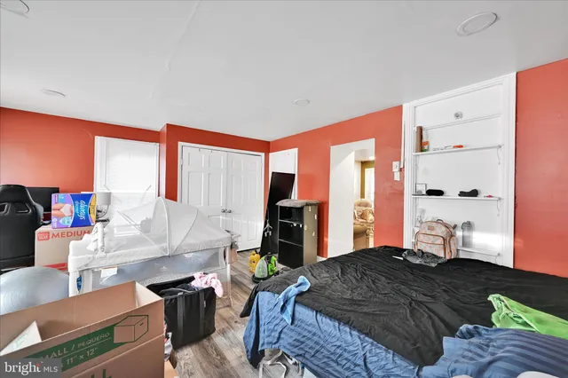 a bedroom with furniture and a large window