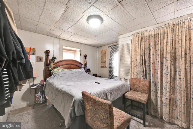 a bedroom with furniture and a large window