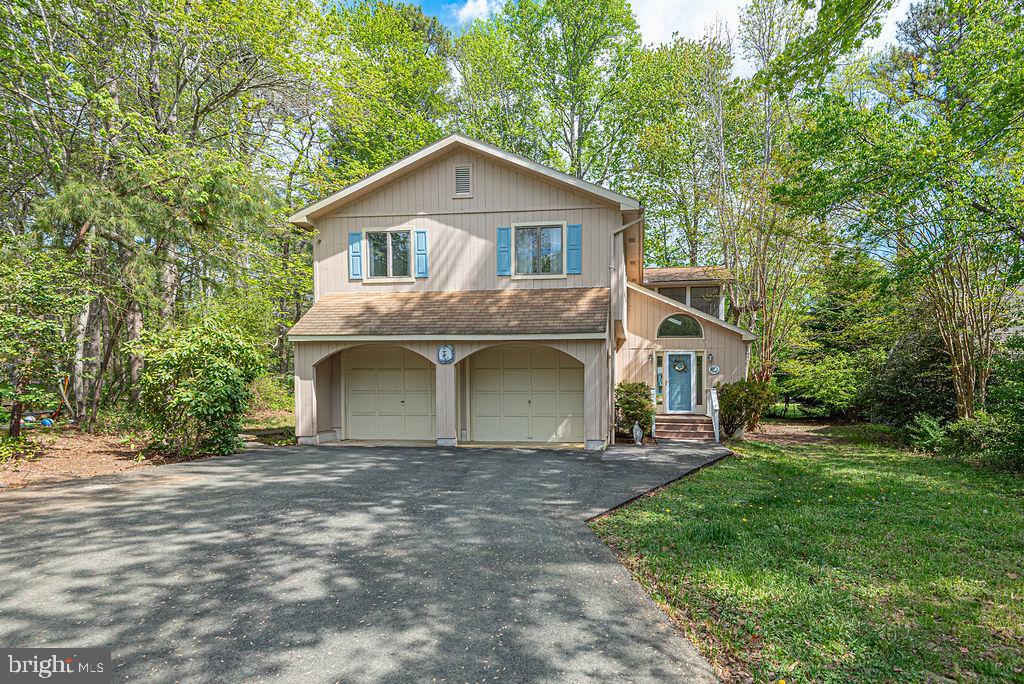 63 Drawbridge Road Ocean Pines, MD 21811 - Photo 80 of 102 a front view of a house with a yard and garage