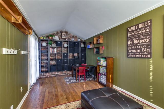 3613 Robin Road Nashville, TN 37204 - Photo 8 of 20 Cool den with brick wall & (non-functioning) fireplace. Shelving. French doors.