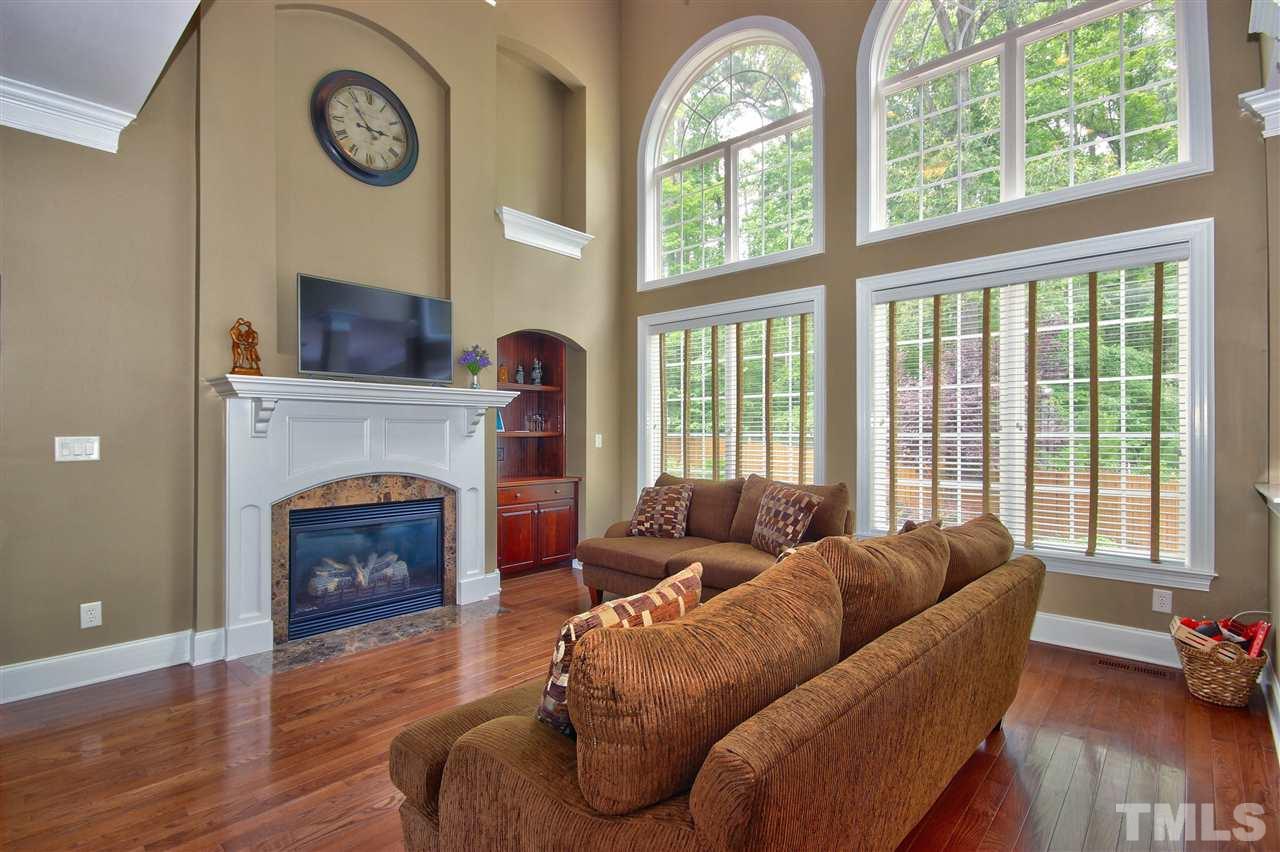 8604 Stonechase Drive Raleigh, NC 27613 - Photo 11 of 25 a living room with furniture a fireplace and a large window