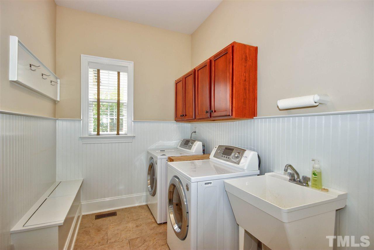 8604 Stonechase Drive Raleigh, NC 27613 - Photo 14 of 25 a utility room with dryer and washer