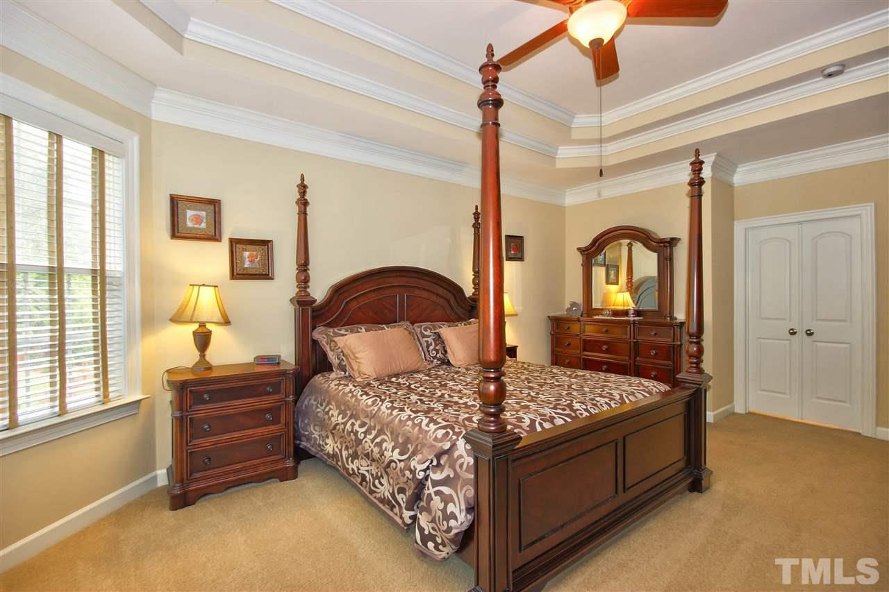 8604 Stonechase Drive Raleigh, NC 27613 - Photo 16 of 25 a bedroom with a bed a dresser and next to a window