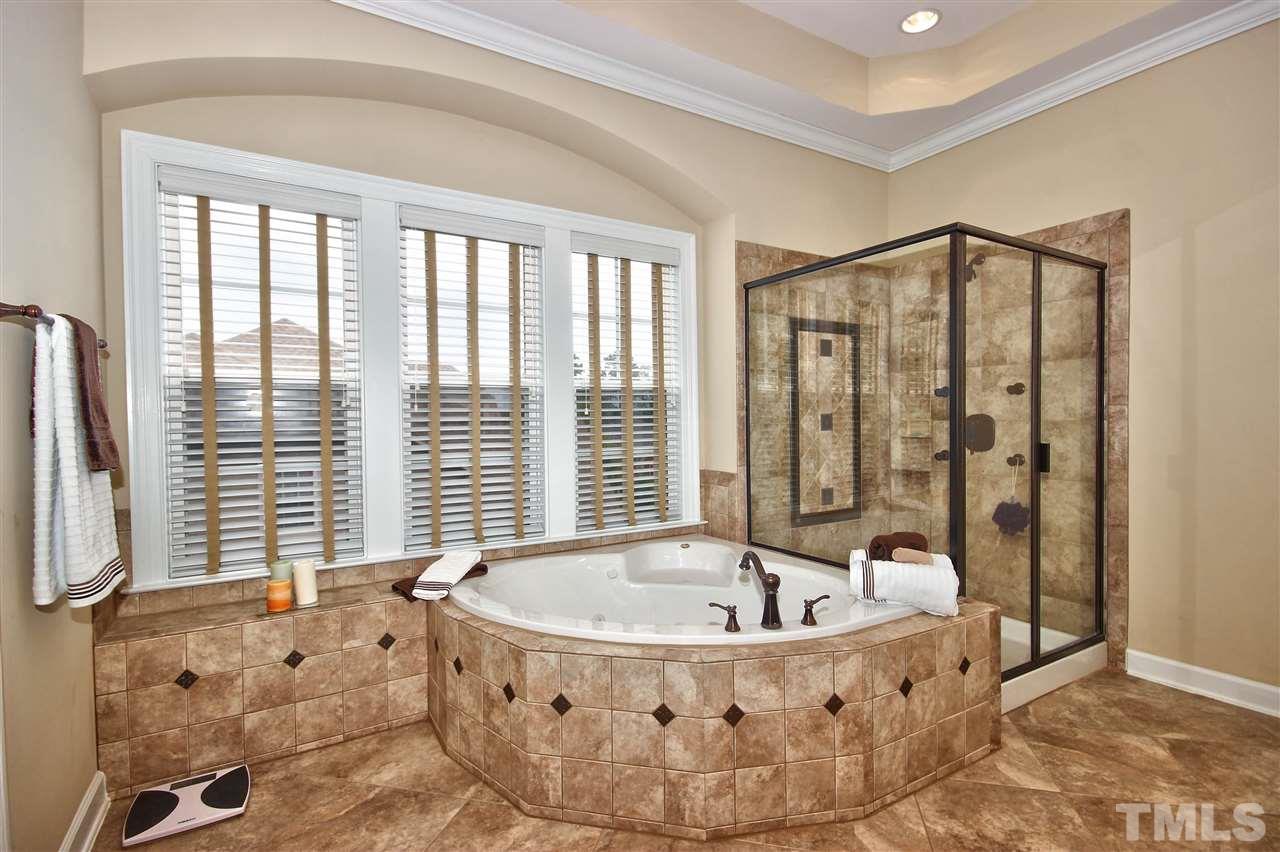 8604 Stonechase Drive Raleigh, NC 27613 - Photo 17 of 25 a spacious bathroom with bathtub and shower