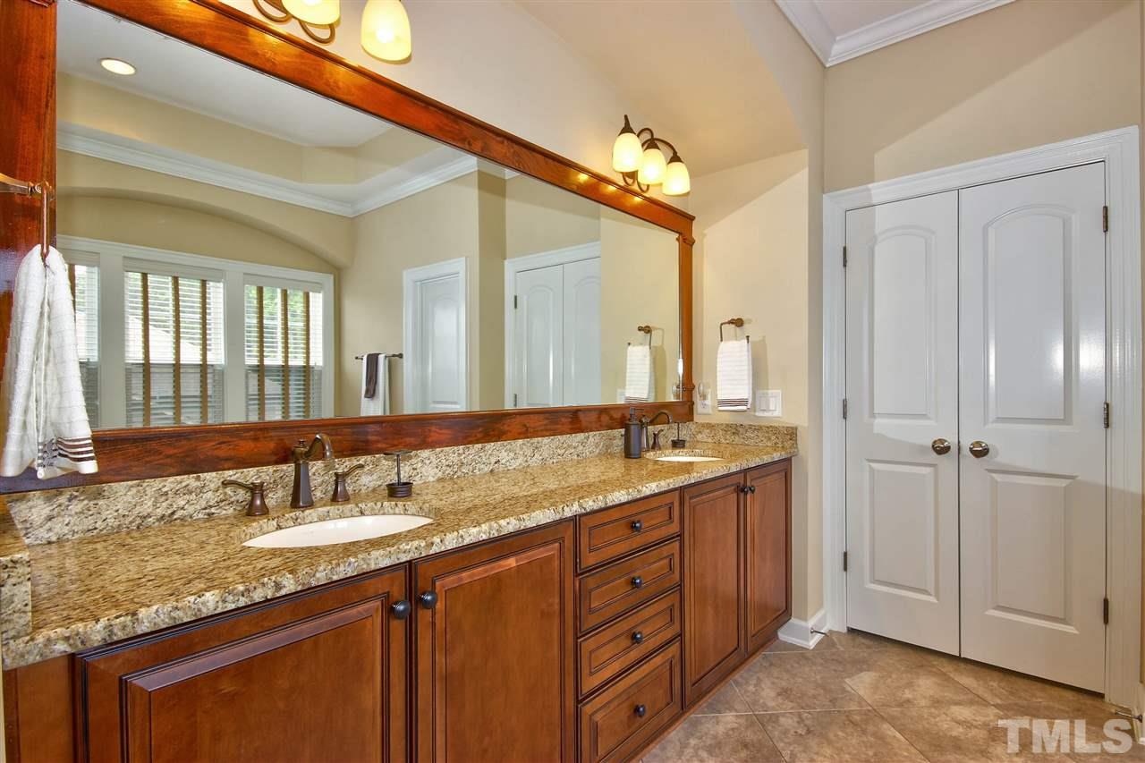 8604 Stonechase Drive Raleigh, NC 27613 - Photo 18 of 25 a bathroom with a granite countertop double vanity sink and a mirror