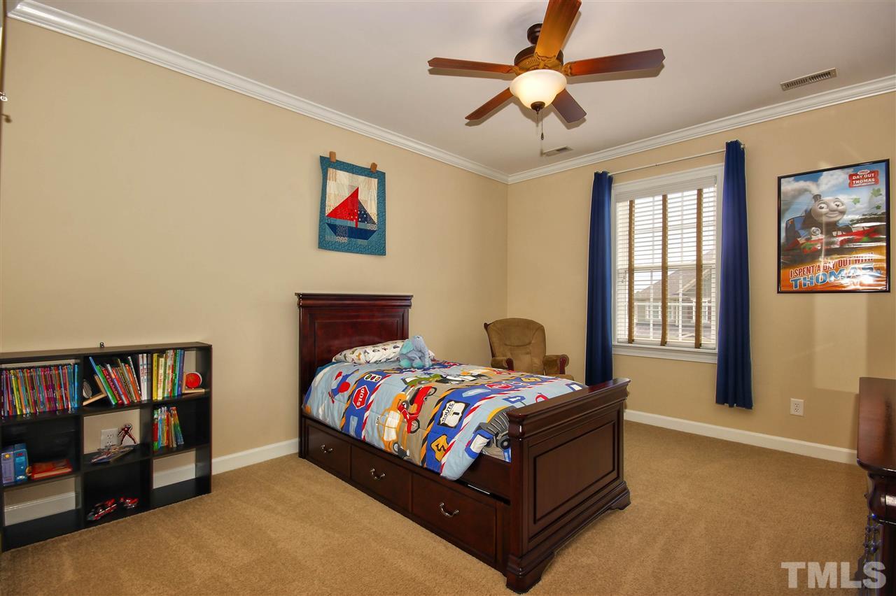 8604 Stonechase Drive Raleigh, NC 27613 - Photo 20 of 25 a bedroom with a bed a book shelf and a window