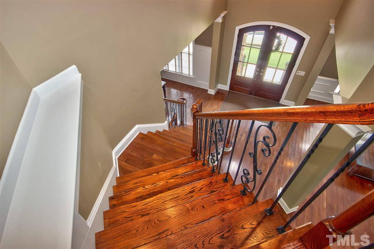 8604 Stonechase Drive Raleigh, NC 27613 - Photo 2 of 25 a view of stairs and with wooden floor