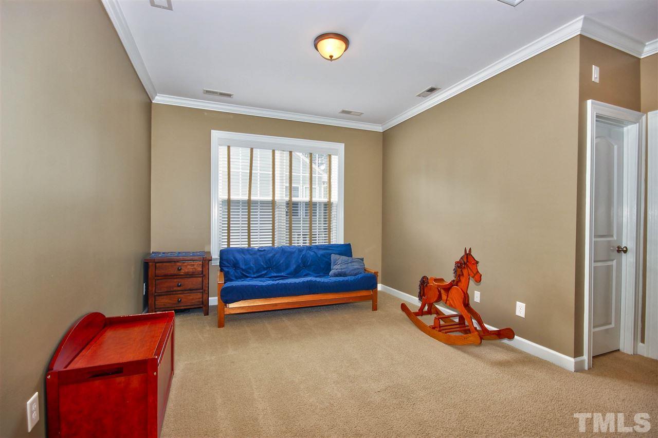 8604 Stonechase Drive Raleigh, NC 27613 - Photo 22 of 25 a bedroom with furniture and a window