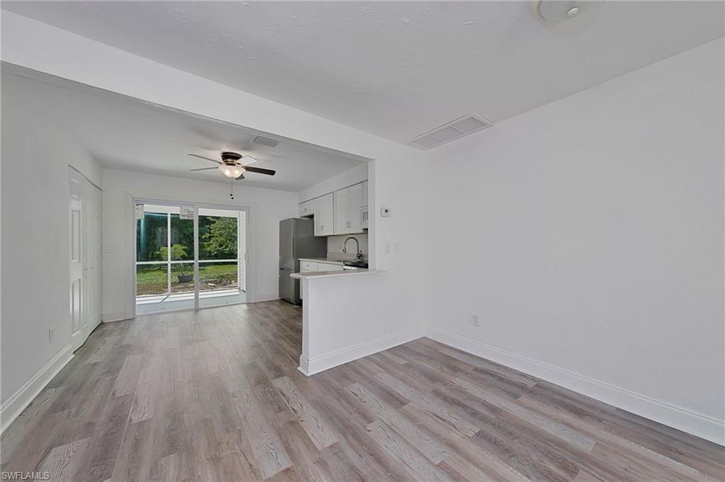 19133 Tangerine Road Fort Myers, FL 33967 - Photo 12 of 17 Unfurnished living room with light hardwood / wood-style flooring, sink, and ceiling fan